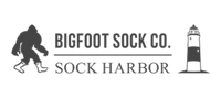 Logo of Bigfoot Sock Co. with a silhouette of a person and a lighthouse on a white background